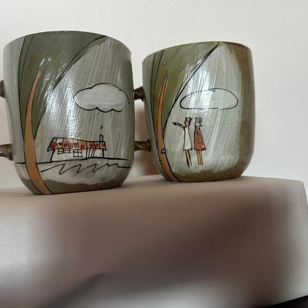 Vintage Hand painted pair of stoneware mugs with unique designs